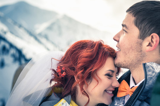 Wedding snowboarders couple just married at mountain winter