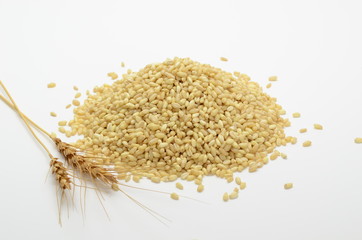 Wheat pile or heap isolated on white background with golden ears