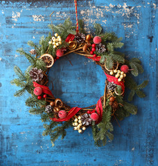 Christmas wreath on the  green rustic wooden background