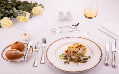 A stake from a cauliflower with coconut sauce, green peas and oyster mushrooms