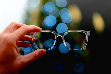 Holding glasses up in front of lights