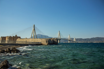 Obraz premium bridge urban city building landmark above sea vivid blue water surface