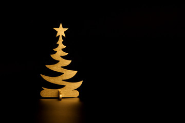 christmas tree painted in gold at black background