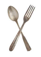 Crossed vintage spoon and fork isolated on bell background. Rustic style.