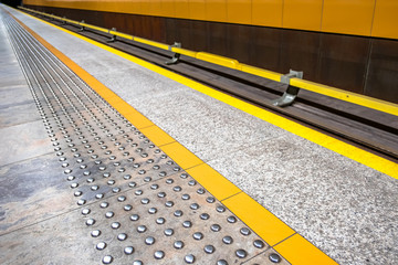 tactile paving for visually impared at subway platform edge. yel