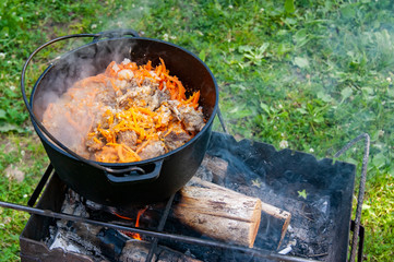 Pilaf on the grill during the trip. In the fresh air.