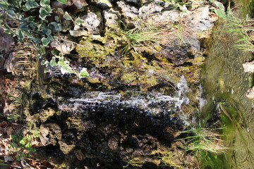 Small waterfall falling on stones