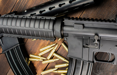 two automatic rifles on wooden background
