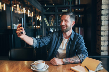 Man looking into the camera while making a selfie