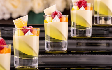 Fresh berries in powder in lemon jelly and lemon mousse