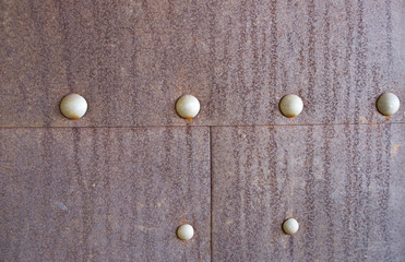 Rusty metal background with rivets for design