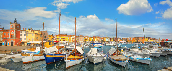 Fototapeta na wymiar Cityscape with bell tower and marina in harbour of Rovinj town. Istria, Croatia