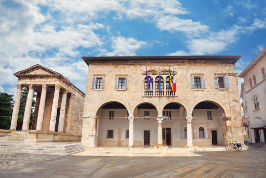  Cityscape with Communal Palace (city hall) and ancient Temple of Augustus in Pula. Istria, Croatia