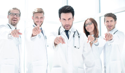 group of confident doctors pointing their finger at you