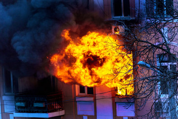 Odessa, Ukraine - Dec. 29, 2016:  fire in an apartment building. Strong bright light and clubs, smoke clouds window of their burning house. Firefighters extinguish fire in house. Work on fire stairs