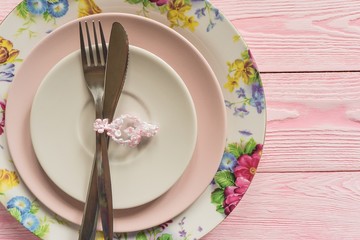 Empty plate and silverware over wooden table background. View from above with copy space
