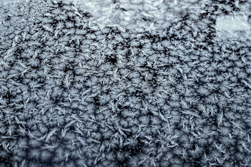 Frost patterns on window glass in winter