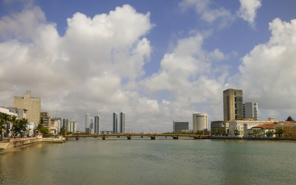 Recife, Brazil - Circa December 2018: A view of Capibaribe river with Mauricio de Nassau bridge and cityscape in the background