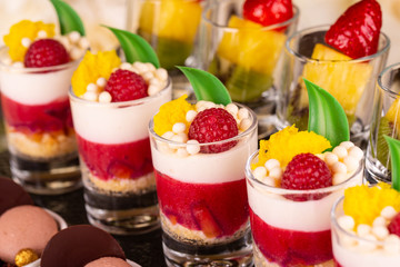 A crimson dessert with berry, vanilla balls and color chocolate