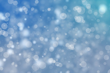 Shiny blue bokeh blur background. Glowing glitter circle particles holiday.