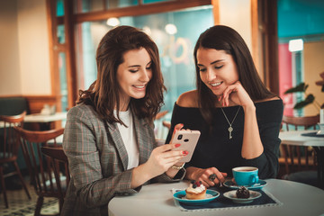 Beaufitul smiling girlfriends taking selfie