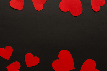 Valentines day. Paper hearts red and white on a black background. Holiday background