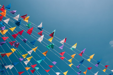 Colorful bunting flags on blue sky on background