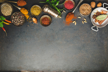 Herbs and spices on dark background, flat lay