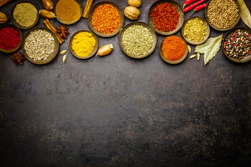 Various bowls of spices over dark background