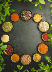 Fototapeta na wymiar Various bowls of spices over dark background