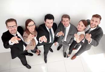 Happy business group pointing at the camera