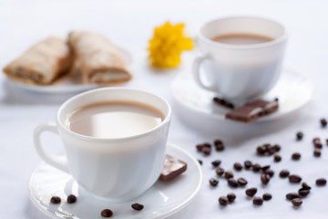 Two cup of coffee, pancakes with jam and milk chocolate. Morning breakfast for two.