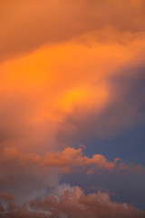 Dramatic clouds at colourful moody sunset