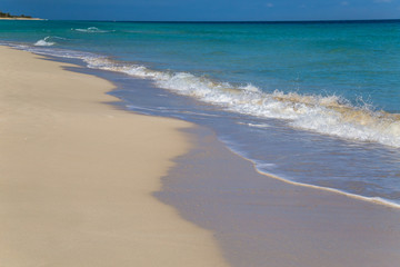 Blue wave on a white sand tropical beach