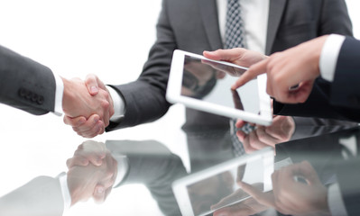 Two confident businessmen shaking hands during a meeting in the
