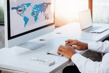 Computer financial specialist working on desktop computer and in office analytics intelligence dashboard on the computer screen showing sales and operations data statistics and key performance indicat