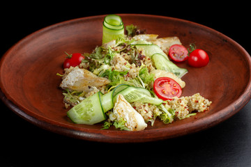 Fish with fresh green leaves salad and quinoa.