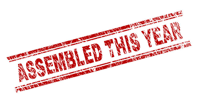 ASSEMBLED THIS YEAR seal stamp with distress texture. Red vector rubber print of ASSEMBLED THIS YEAR text with corroded texture. Text title is placed between double parallel lines.