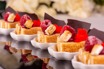 Cake from puff pastry with raspberry in icing sugar with chocolate