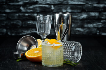 Cocktail Gin tonic with citrus in a glass. On a wooden background. Top view. Free copy space.