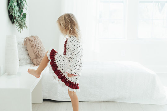 Young girl with her foot on a table