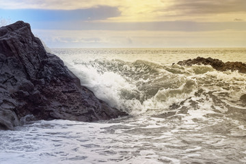 Waves on the rocky coast at golden hour