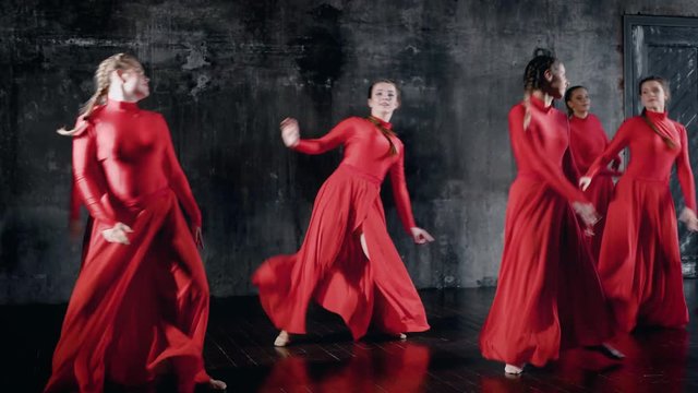 Group of smiling talented girl dancing together, group dance rehearsal.