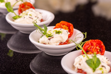 Dried tomatoes with cheese mozzarella with greens