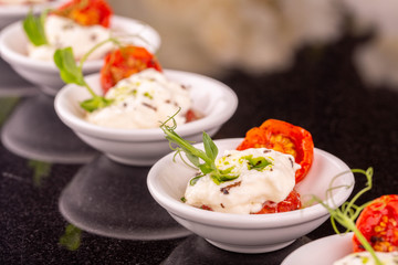 Cheese mozzarella with dried tomatoes with greens