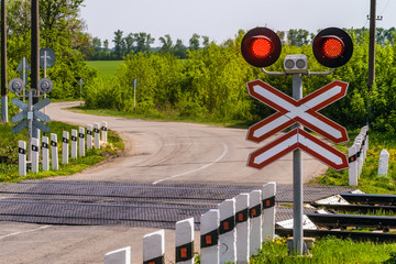 Railway traffic lights with a red signal. Railway and road crossing. Forbidding Motion signal.
