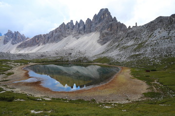 Dolomite Alp mountain near the lakewith reflection in Italy