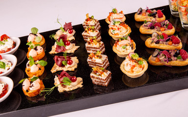 Brusketa with a guinea fowl, berries, greens, red caviar, mousse, raspberry, blackberry