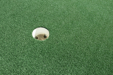 Golf green with hole.