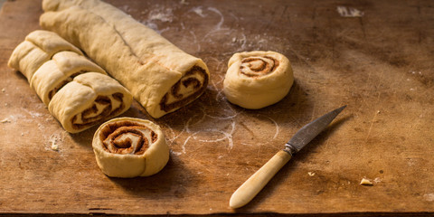 cinnamon buns - Cinnabon cooking process raw dough. (food background). copy space